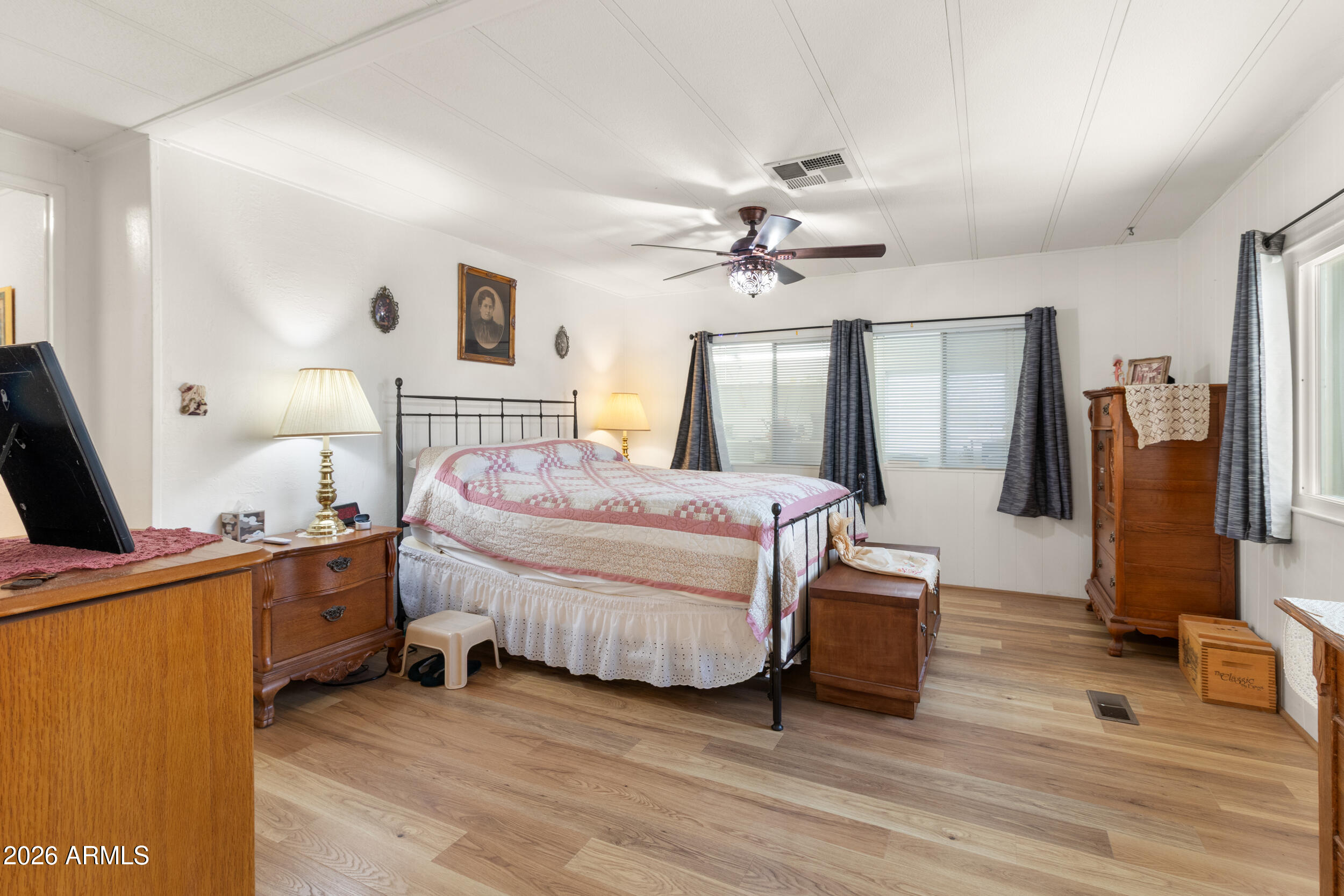 9302 East Broadway Road, Unit 178 Mesa, AZ 85208 - Photo 25 of 56 a spacious bedroom with a bed and a flat screen tv