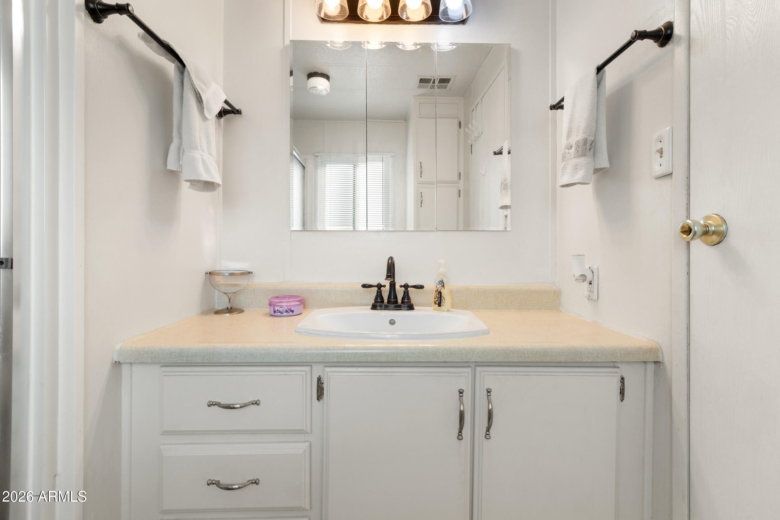 9302 East Broadway Road, Unit 178 Mesa, AZ 85208 - Photo 27 of 56 a bathroom with a sink vanity and a mirror