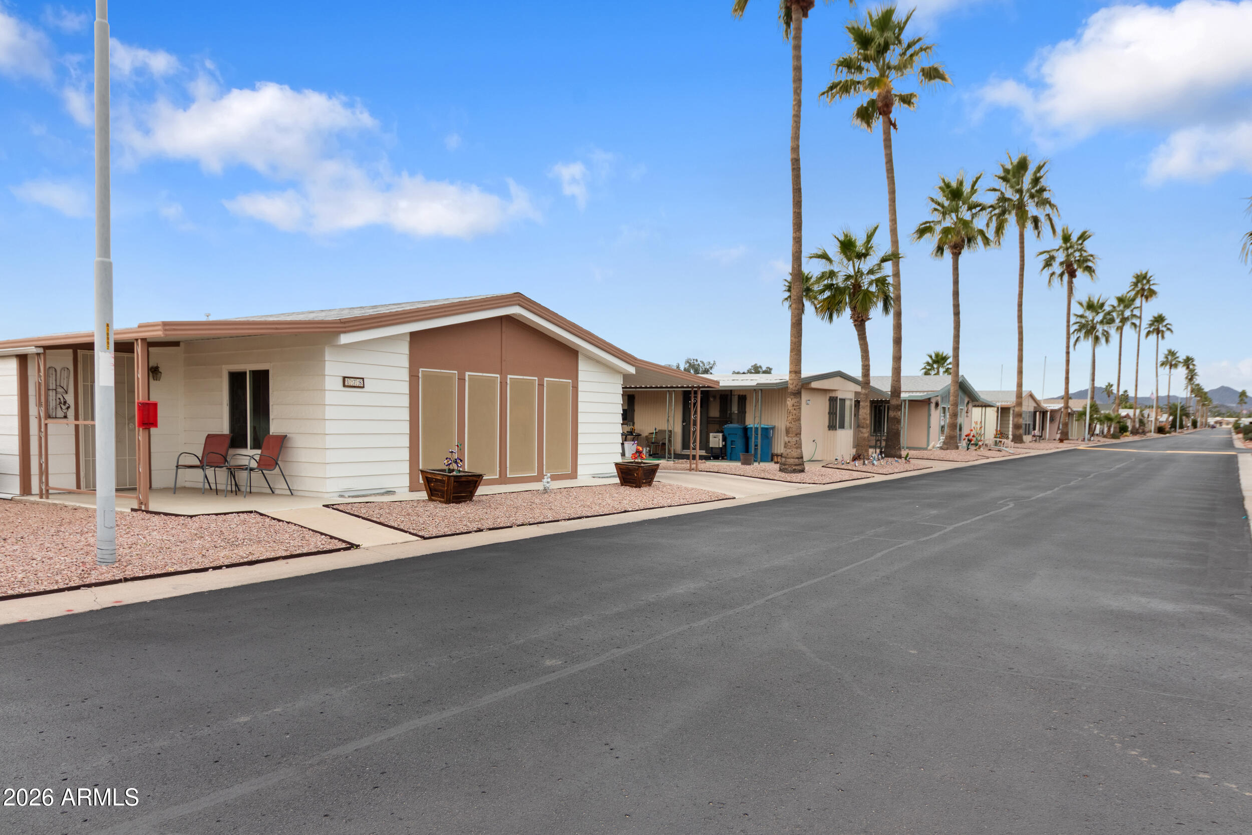 9302 East Broadway Road, Unit 178 Mesa, AZ 85208 - Photo 32 of 56 a view of a house with a outdoor space and palm trees