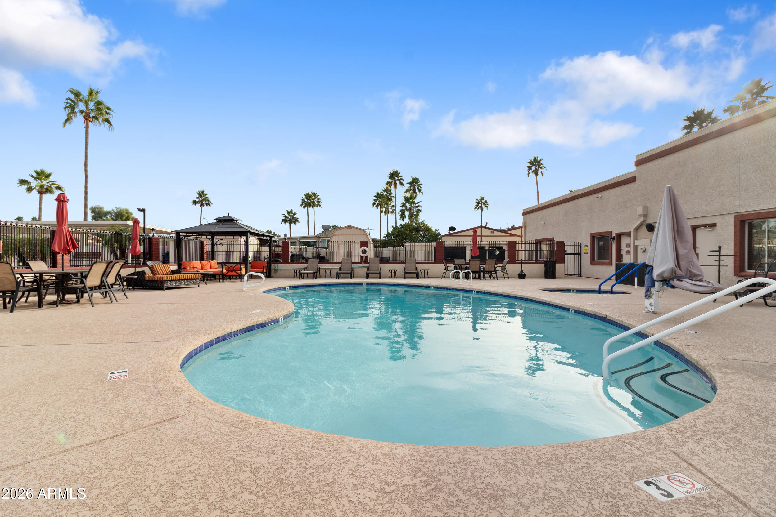 9302 East Broadway Road, Unit 178 Mesa, AZ 85208 - Photo 42 of 56 a view of a swimming pool with outdoor seating