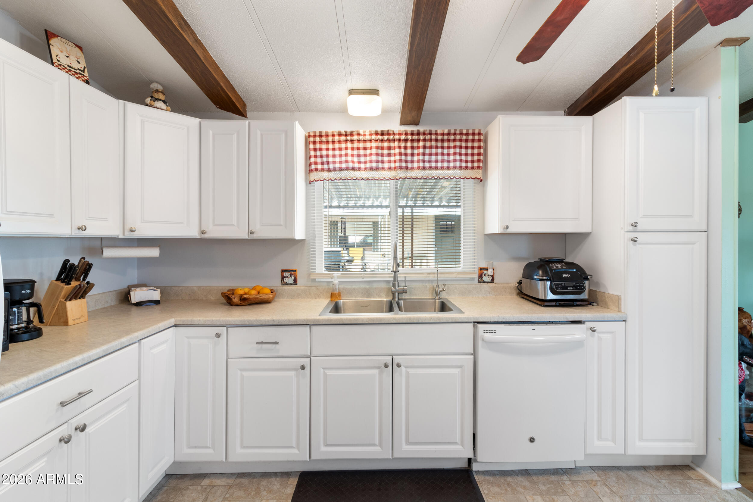 9302 East Broadway Road, Unit 178 Mesa, AZ 85208 - Photo 7 of 56 a kitchen with white cabinets and white appliances