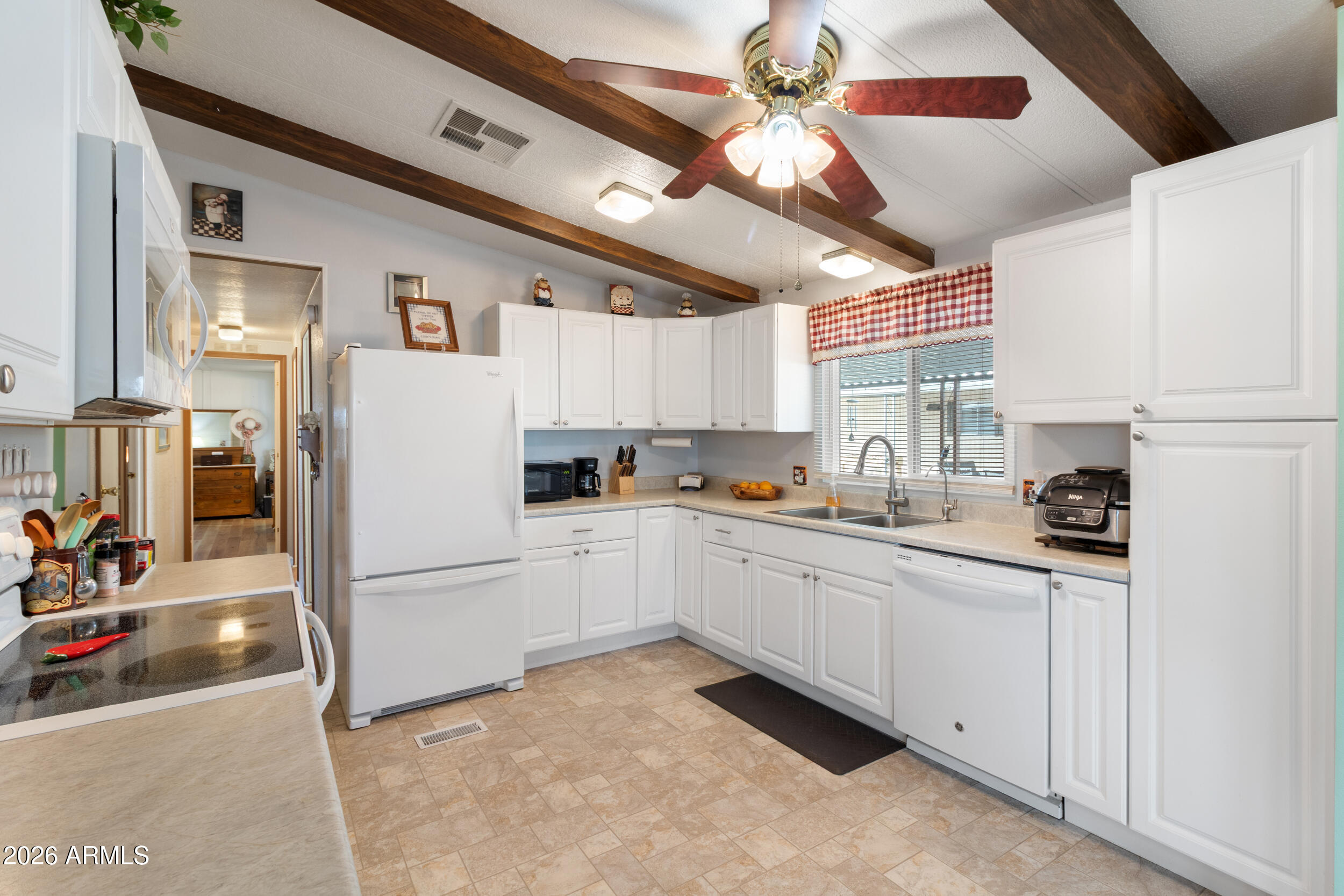 9302 East Broadway Road, Unit 178 Mesa, AZ 85208 - Photo 8 of 56 a kitchen with granite countertop a refrigerator and a sink