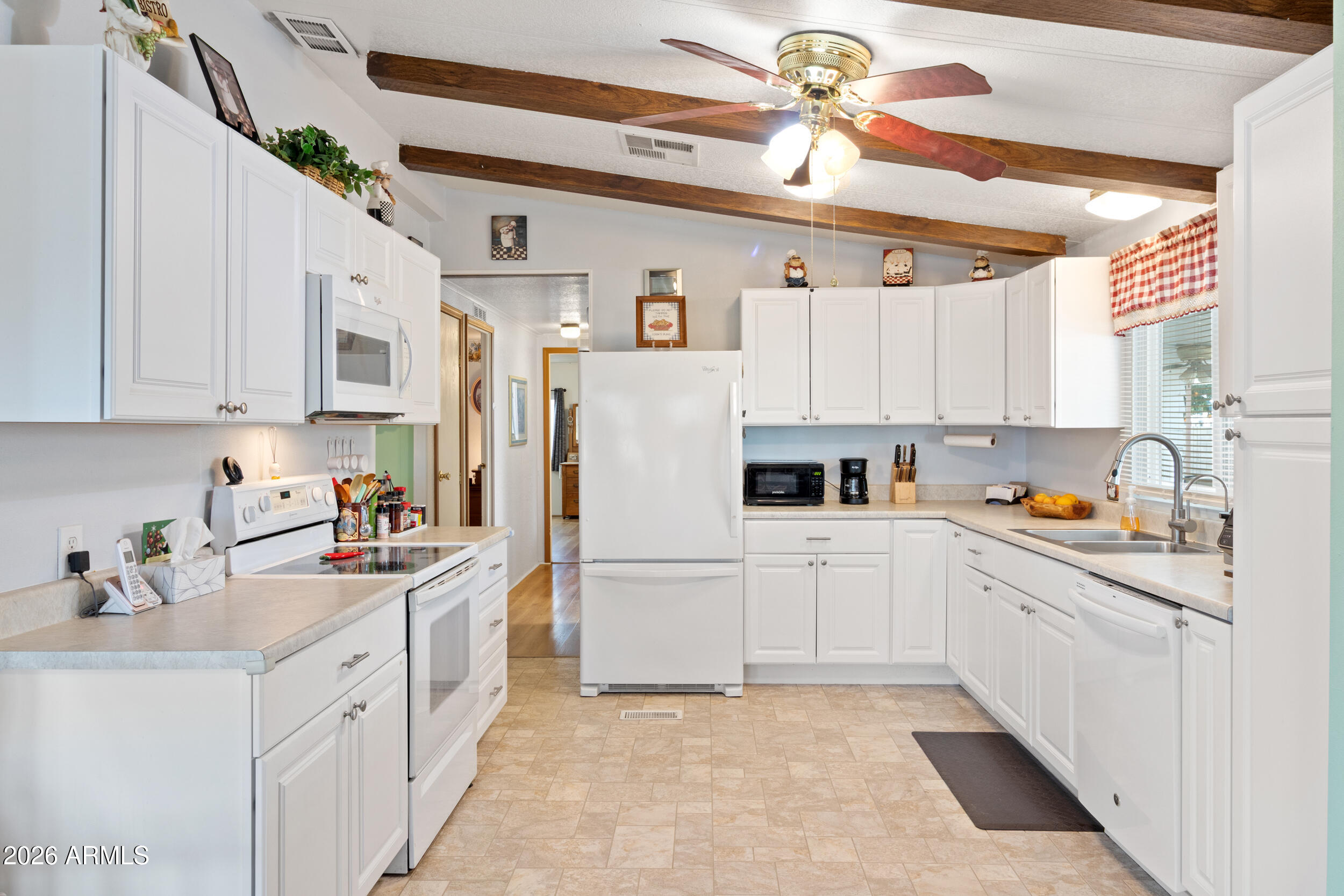 9302 East Broadway Road, Unit 178 Mesa, AZ 85208 - Photo 9 of 56 a kitchen with stainless steel appliances white cabinets and a sink