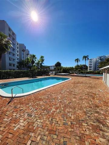 a view of a swimming pool with an outdoor space and seating area