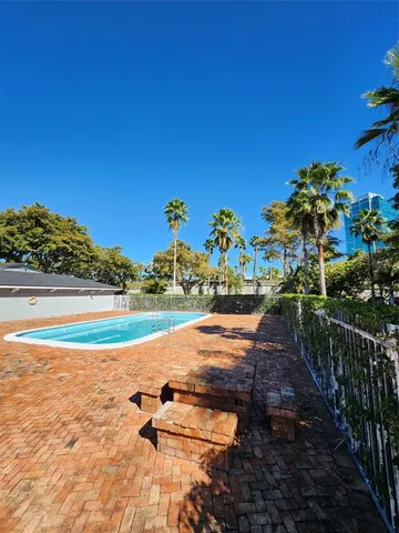 a view of a large building with yard and seating area
