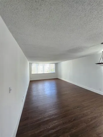 a view of wooden floor and windows in a room