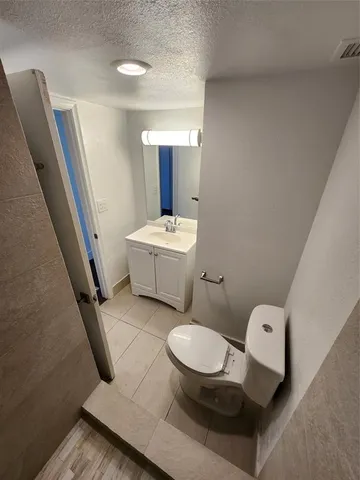 a white toilet sitting next to a bathroom sink