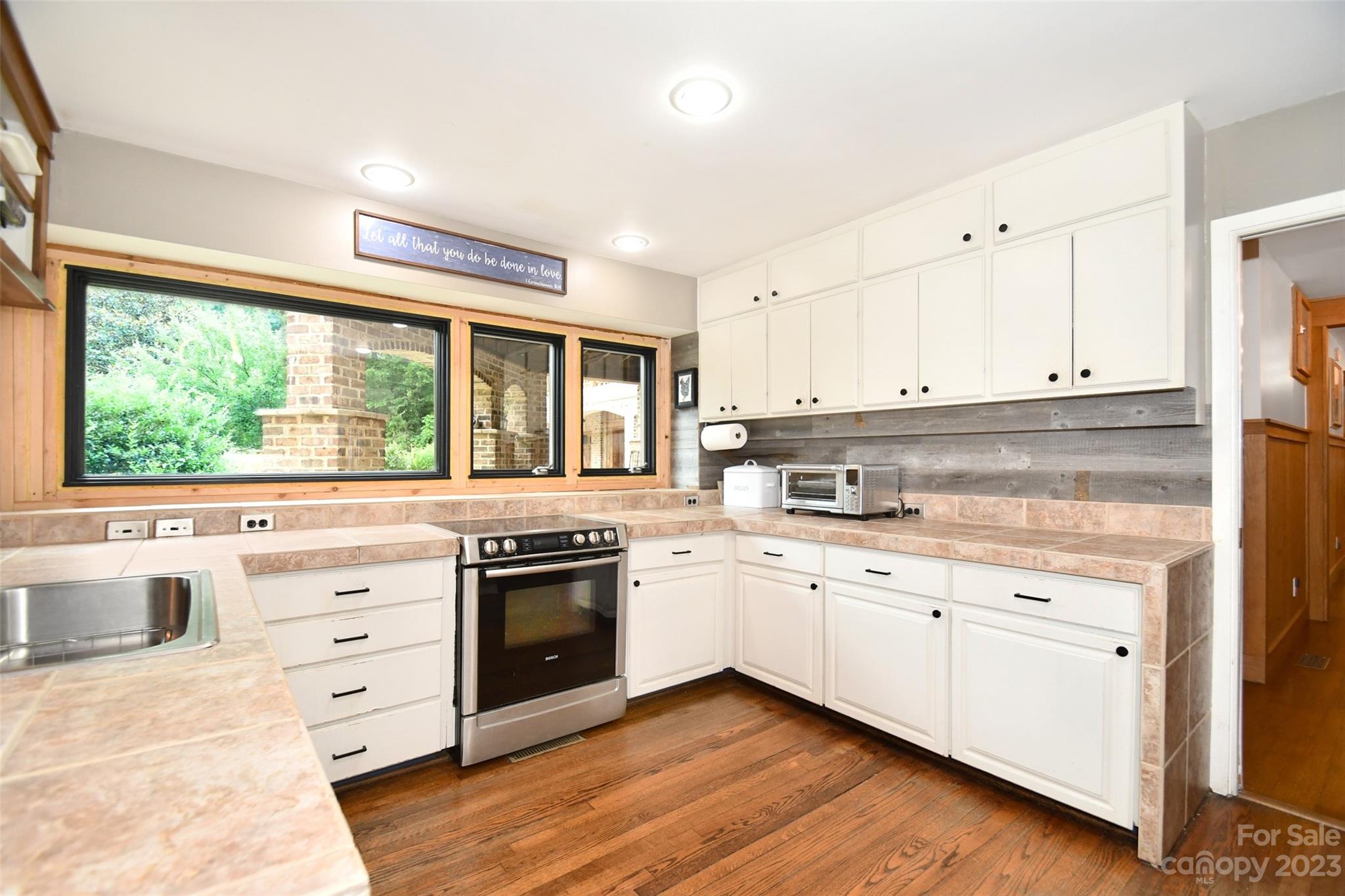 19201 Davidson-Concord Road Davidson, NC 28036 - Photo 11 of 47 a kitchen with stainless steel appliances granite countertop a stove and white cabinets