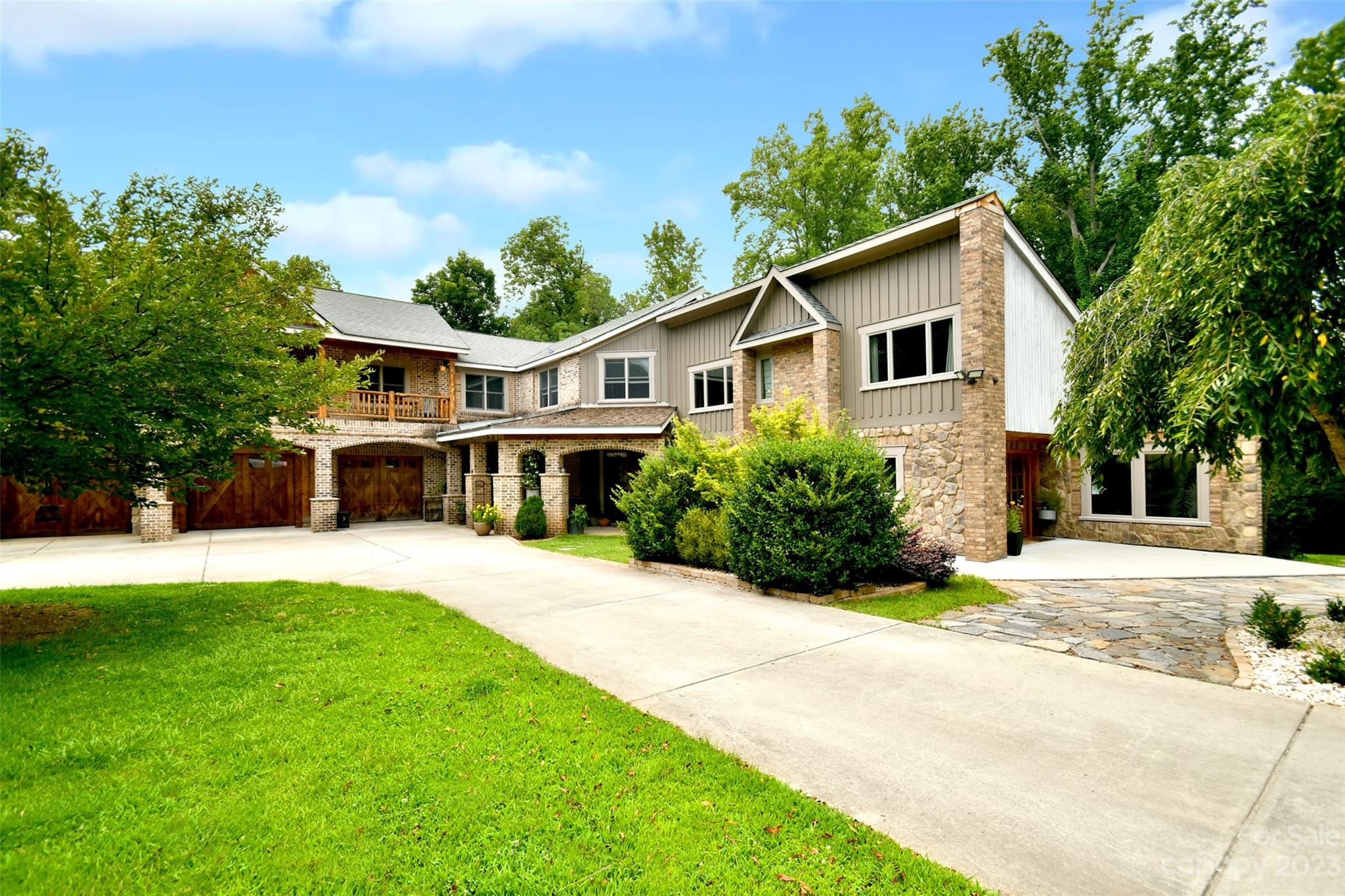 19201 Davidson-Concord Road Davidson, NC 28036 - Photo 2 of 47 a front view of a house with a yard and potted plants