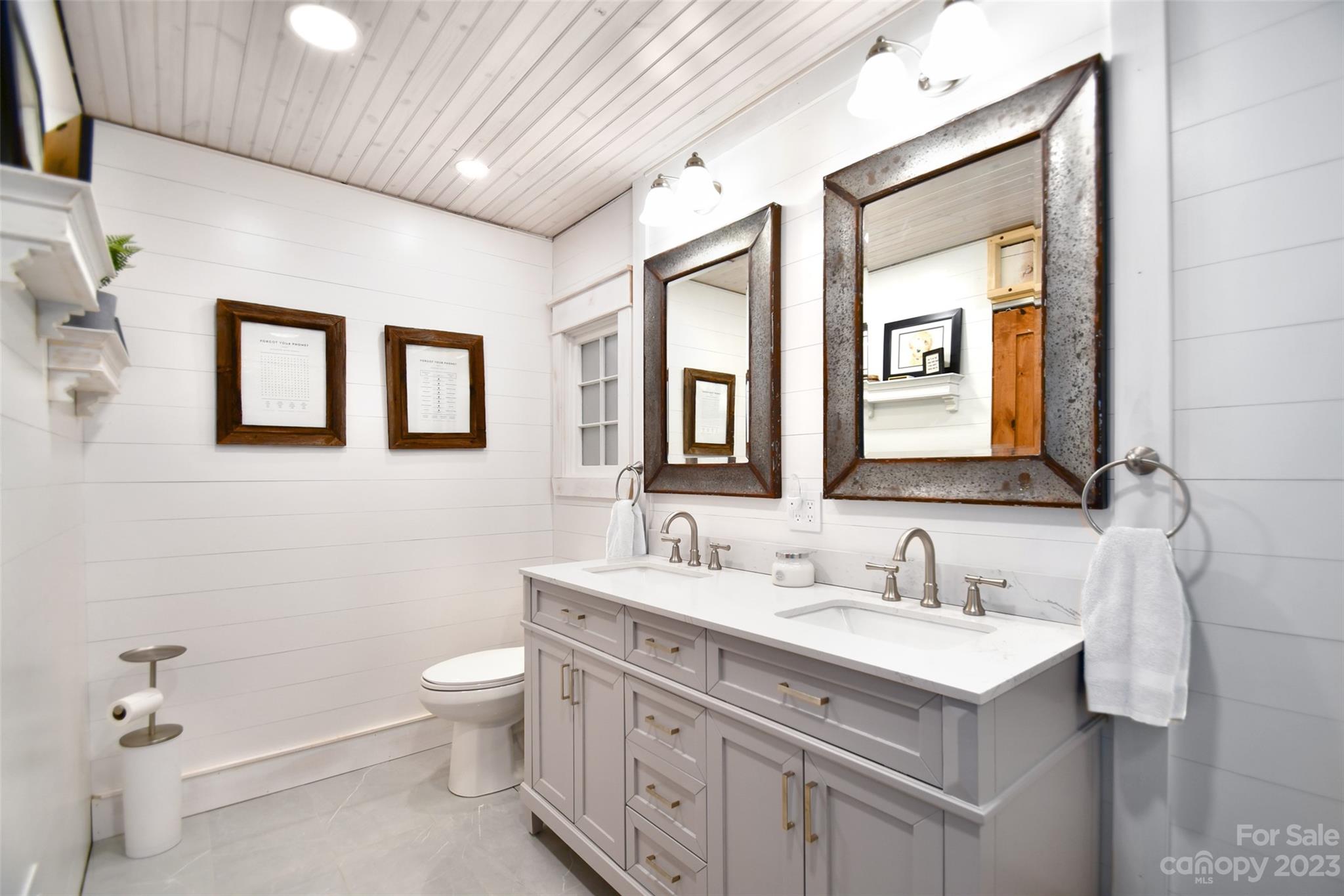19201 Davidson-Concord Road Davidson, NC 28036 - Photo 22 of 47 a bathroom with a double vanity sink toilet and a mirror