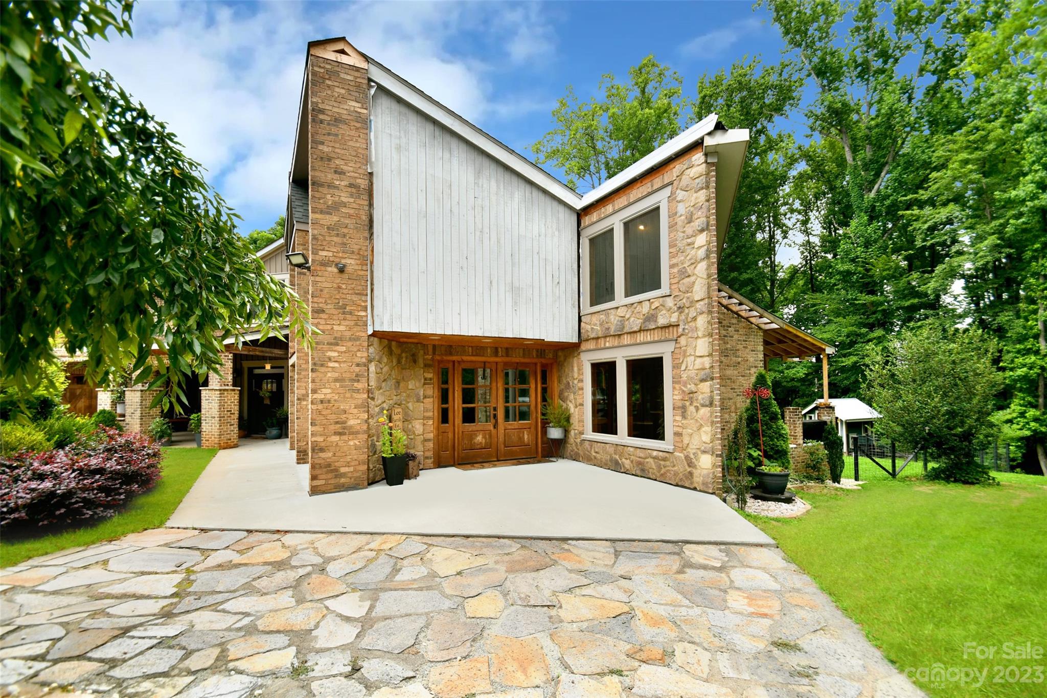 19201 Davidson-Concord Road Davidson, NC 28036 - Photo 3 of 47 a front view of a house with a yard and trees