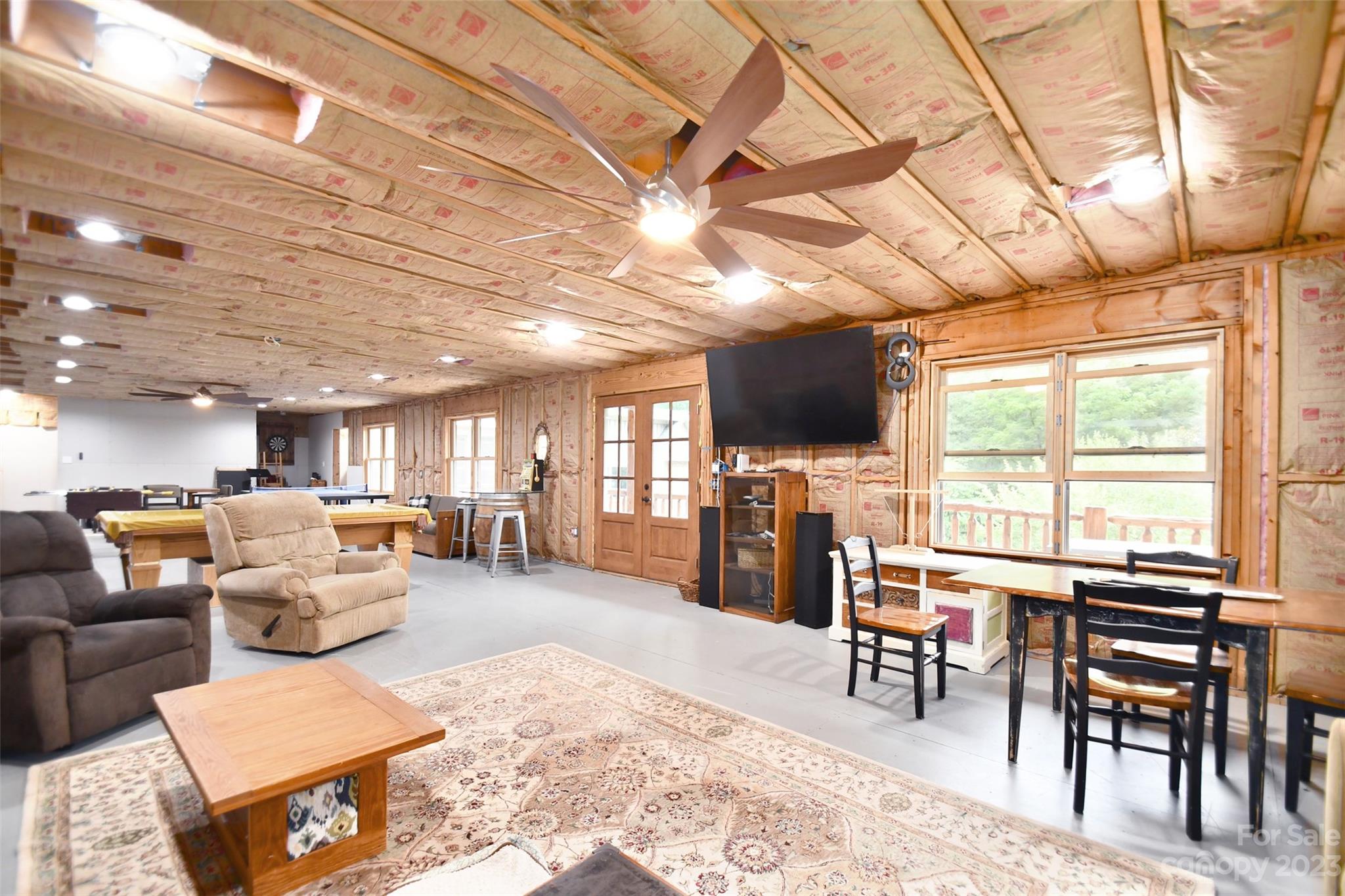 19201 Davidson-Concord Road Davidson, NC 28036 - Photo 32 of 47 a living room with furniture a flat screen tv and a large window