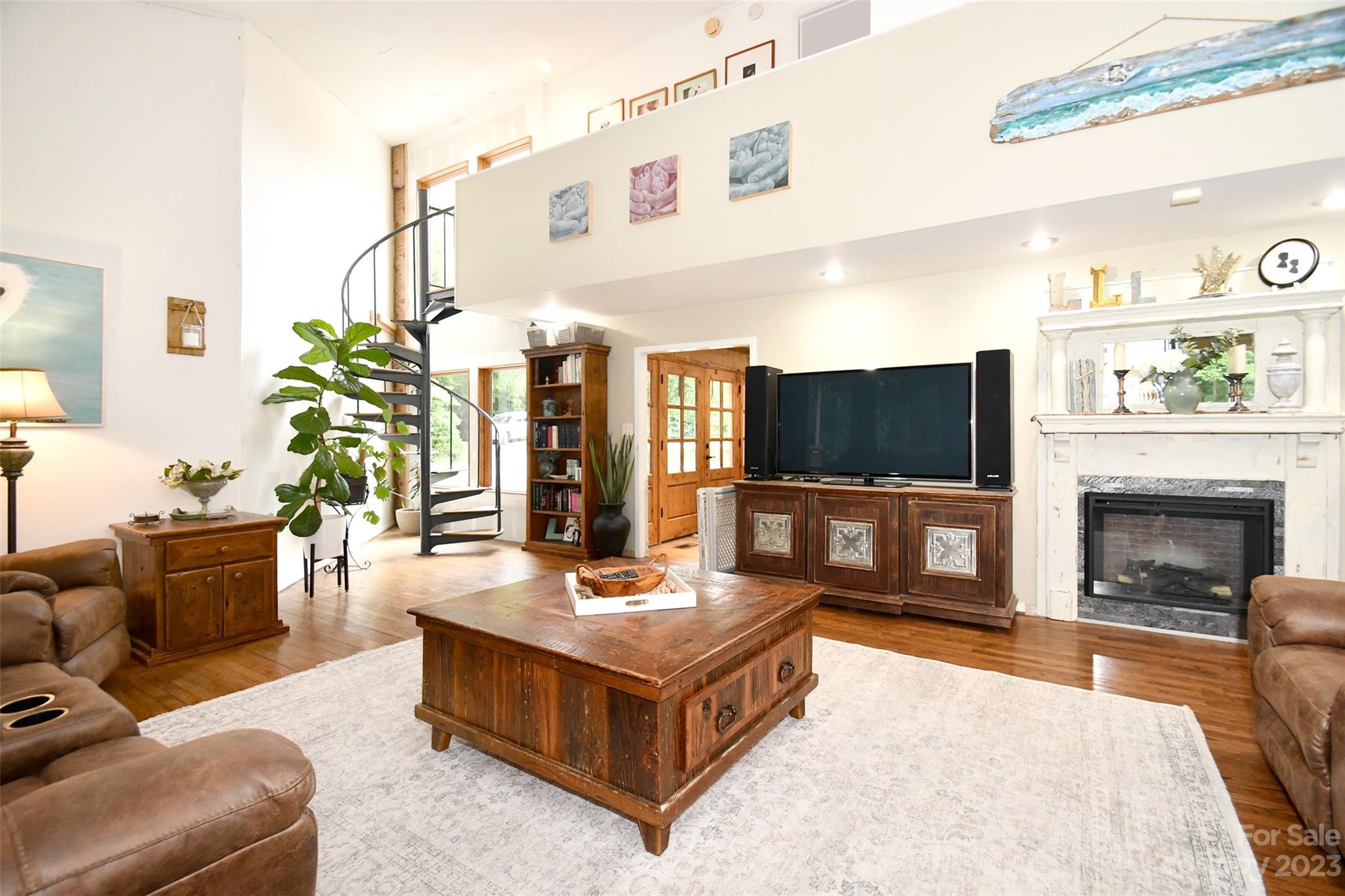 19201 Davidson-Concord Road Davidson, NC 28036 - Photo 7 of 47 a living room with furniture a flat screen tv and a fireplace