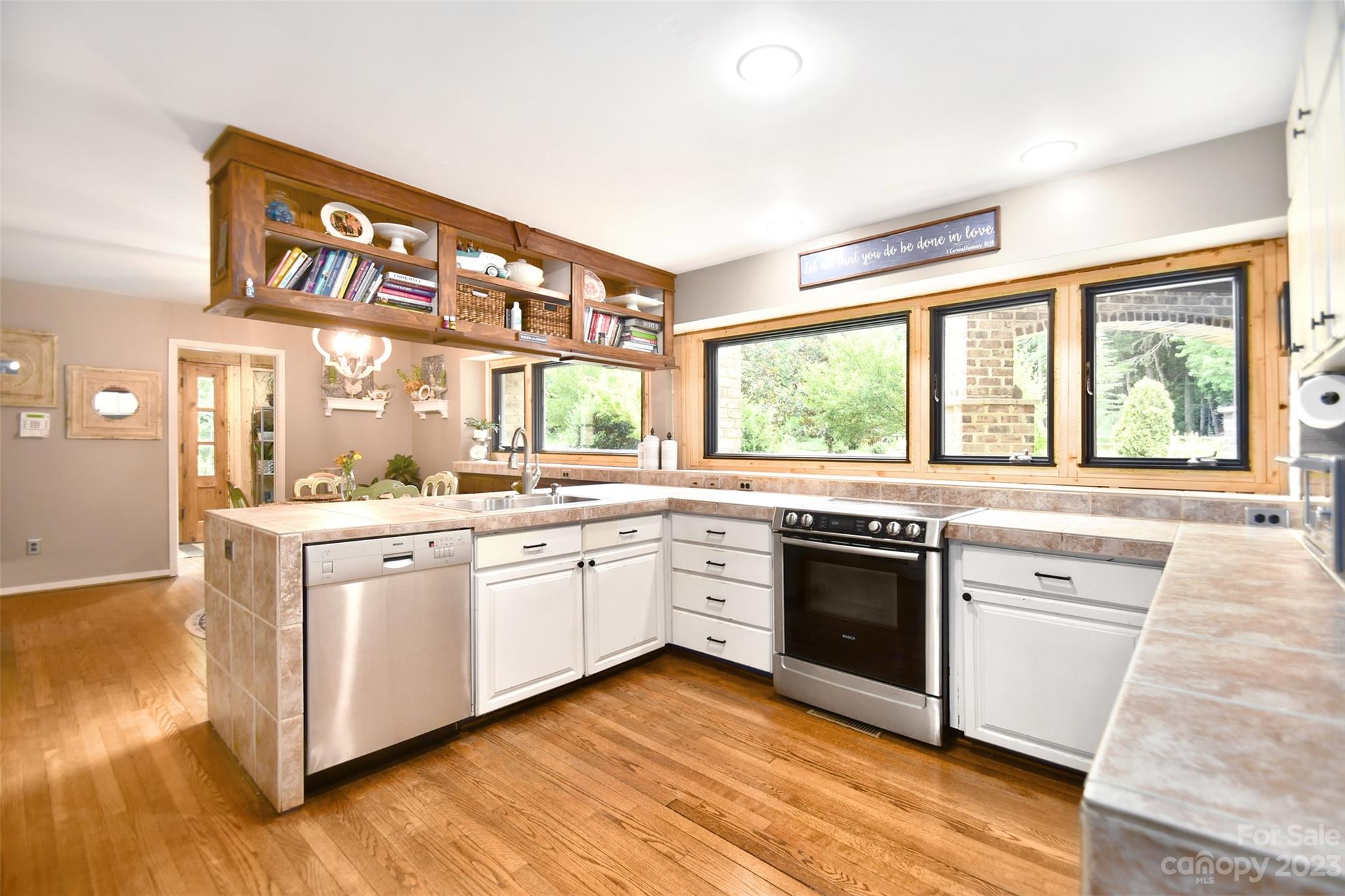 19201 Davidson-Concord Road Davidson, NC 28036 - Photo 10 of 47 a large kitchen with granite countertop a stove top oven a sink and dishwasher with wooden floor