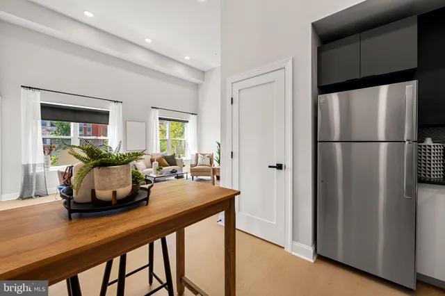 a kitchen with a refrigerator and a table