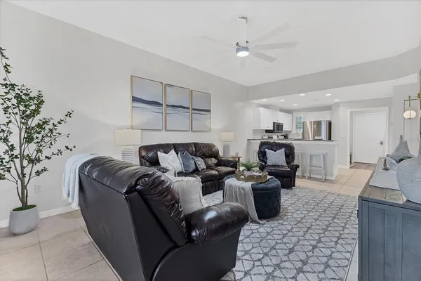 a living room with furniture and flowers