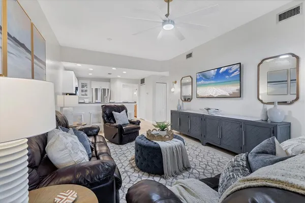 a living room with furniture and a chandelier