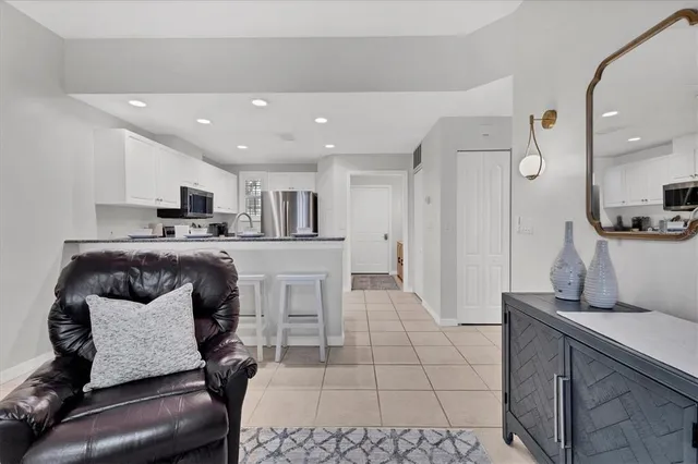 a living room with furniture and kitchen view