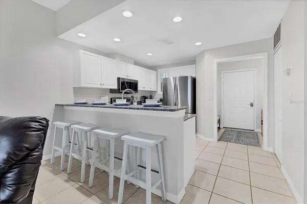 a kitchen with stainless steel appliances a refrigerator stove microwave and sink