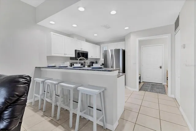 a kitchen with stainless steel appliances a refrigerator stove microwave and sink