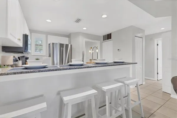 a kitchen with stainless steel appliances a sink and a refrigerator