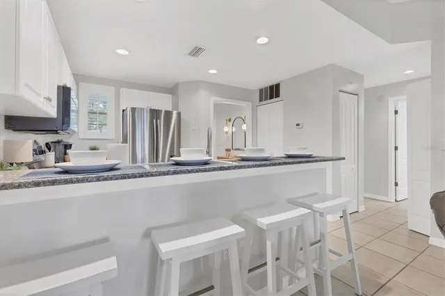 a kitchen with stainless steel appliances a sink and a refrigerator
