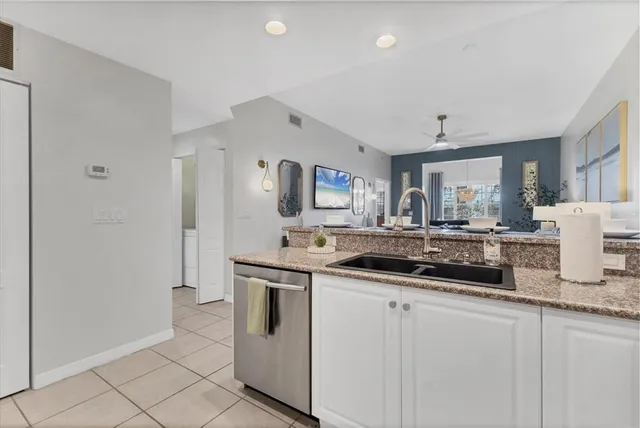 a kitchen with stainless steel appliances granite countertop a sink and cabinets