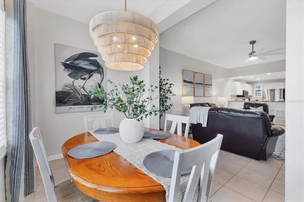a dining room with furniture a livingroom and chandelier