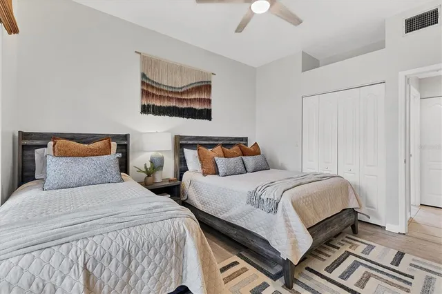 a bedroom with two beds and a chandelier