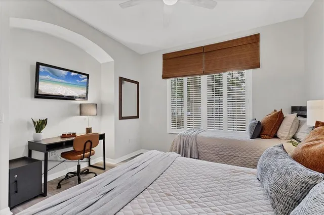 a bedroom with a bed and a window