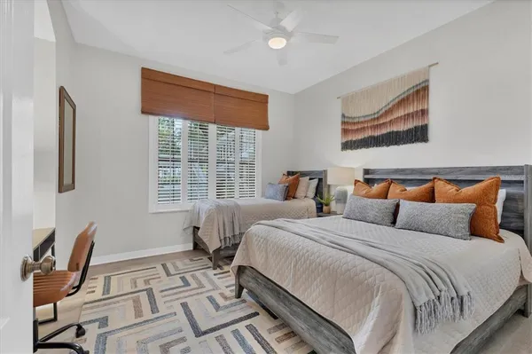 a bedroom with double bed windows and a flat screen tv
