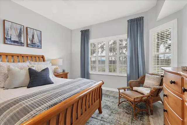 a bedroom with a bed and a large window