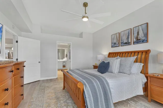 a bedroom with a large bed and a chandelier