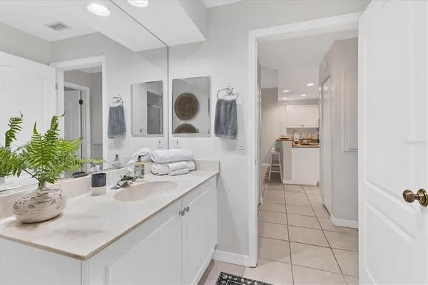 a bathroom with a sink a mirror and shower