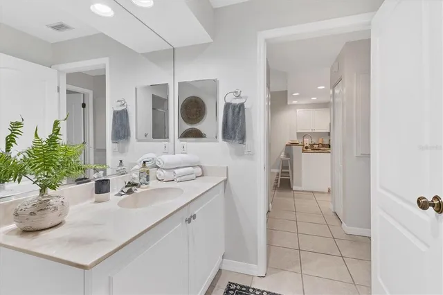 a bathroom with a sink a mirror and shower