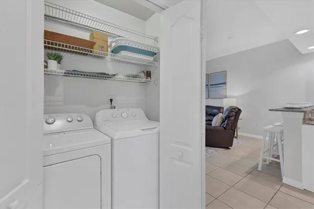 a view of washer and dryer with kitchen in the background