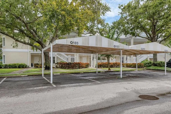 a patio with a table and chairs under an umbrella
