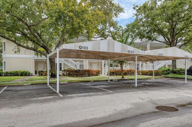 a patio with a table and chairs under an umbrella