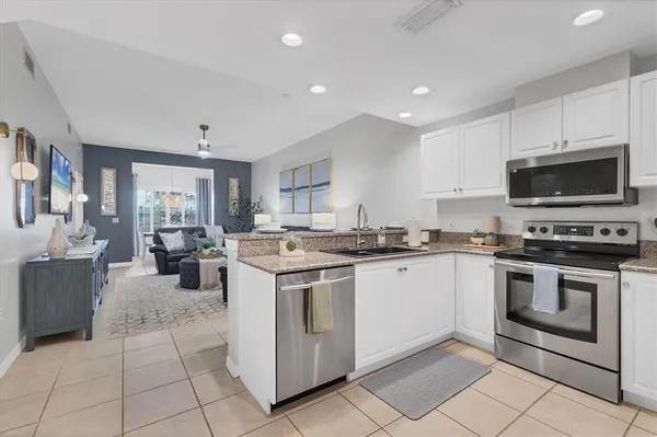 a kitchen with a stove top oven and cabinets