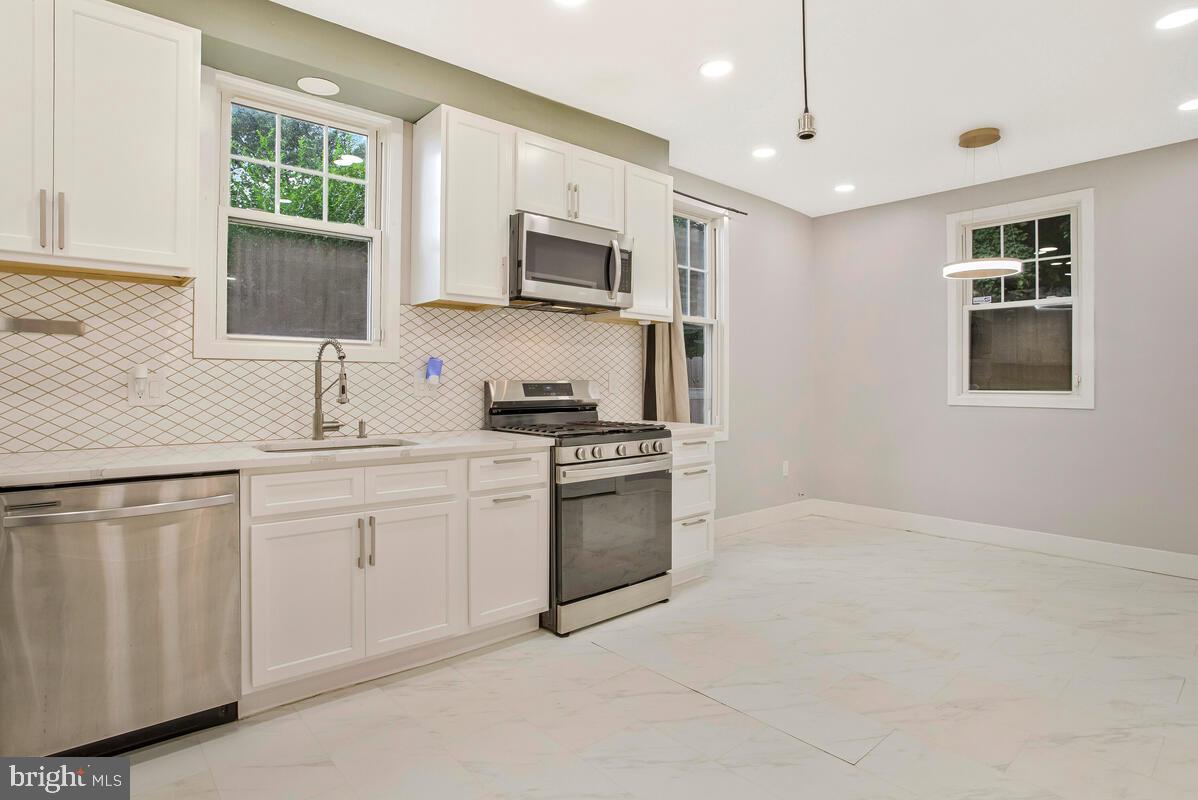 6204 Everall Avenue Baltimore, MD 21206 - Photo 11 of 34 a kitchen with white cabinets and sink