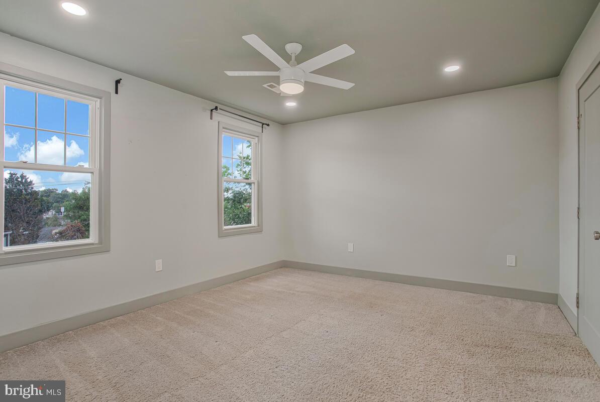 6204 Everall Avenue Baltimore, MD 21206 - Photo 20 of 34 an empty room with windows and ceiling fan