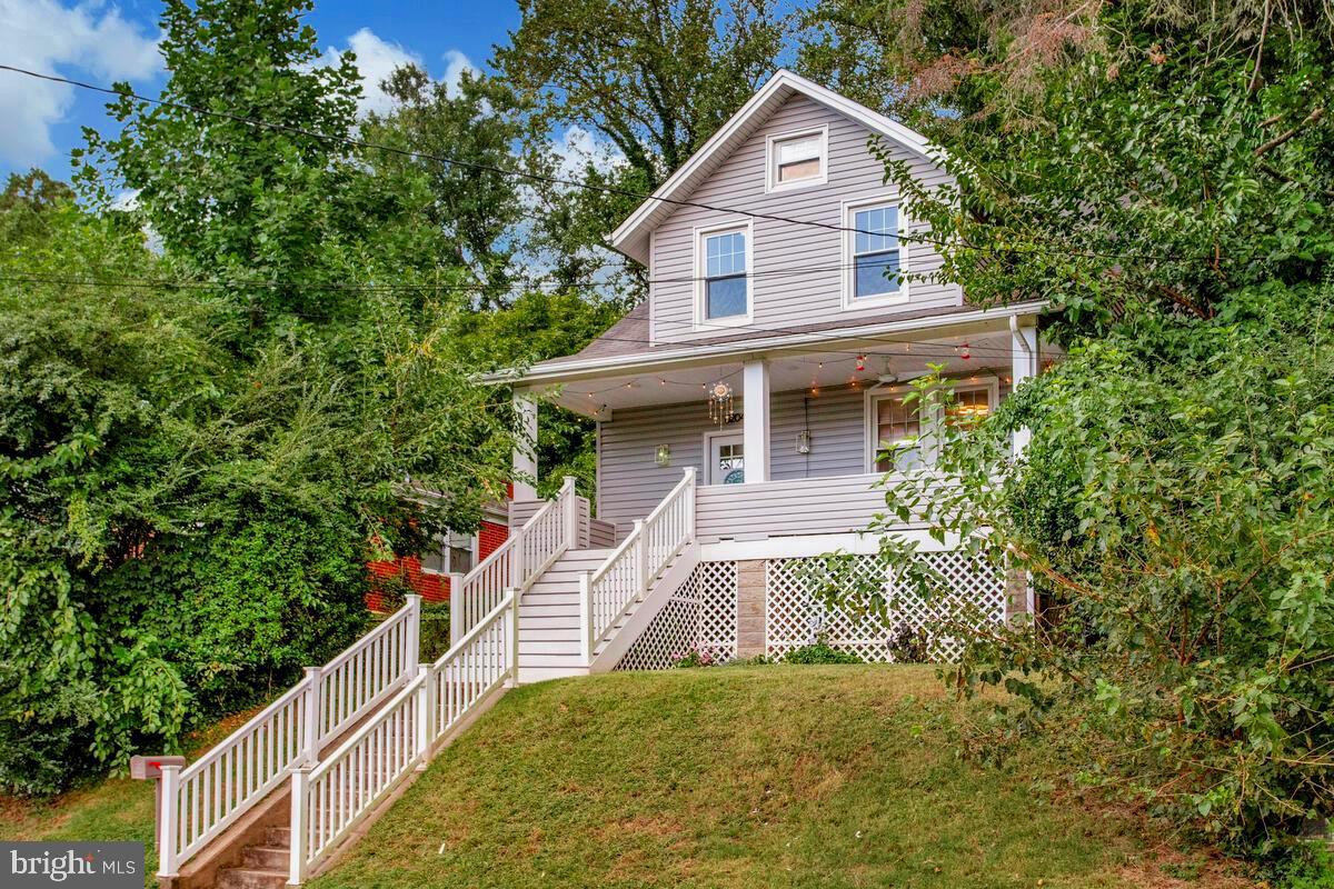 6204 Everall Avenue Baltimore, MD 21206 - Photo 2 of 34 a front view of a house with a yard and trees