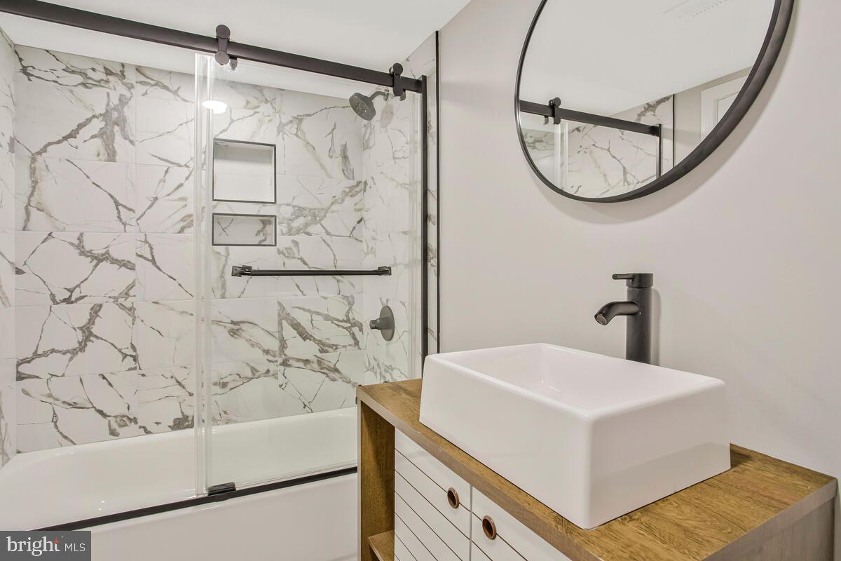 6204 Everall Avenue Baltimore, MD 21206 - Photo 22 of 34 a bathroom with a sink and a mirror