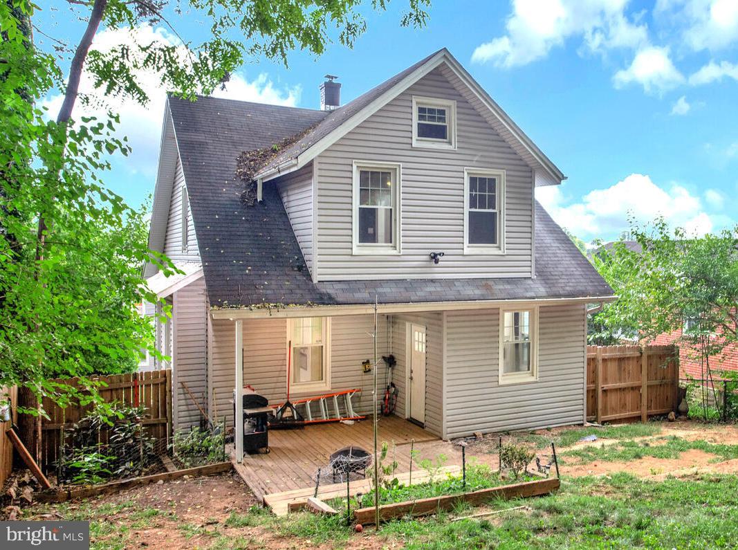 6204 Everall Avenue Baltimore, MD 21206 - Photo 33 of 34 a front view of a house with a yard and outdoor seating