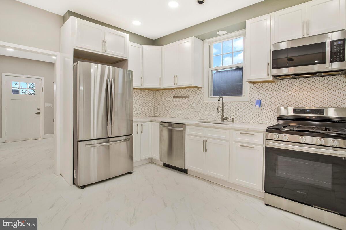 6204 Everall Avenue Baltimore, MD 21206 - Photo 9 of 34 a kitchen with appliances a sink cabinets and a counter top space