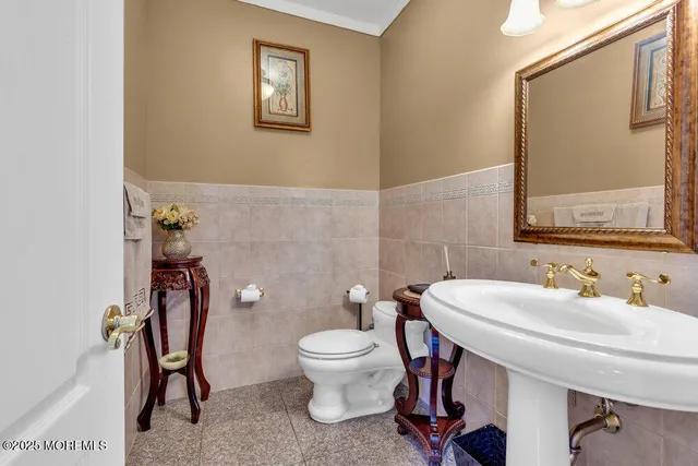 a kitchen with a refrigerator a stove a sink a dining table and chairs