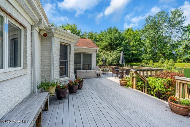a view of a porch with wooden floor and windows