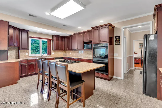 a dining room with furniture and a view of kitchen