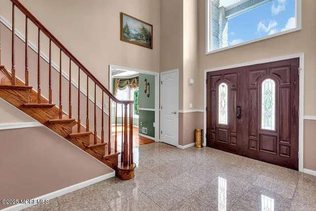 a living room with furniture a rug and a painting on the wall