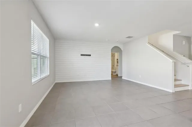 an empty room with windows and entrance